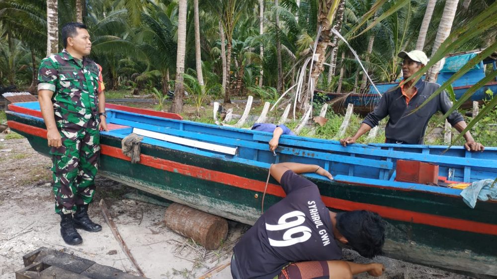 Babinsa Serka Harahap Komsos Dengan Nelayan Yang Sedang Perbaiki Perahu
